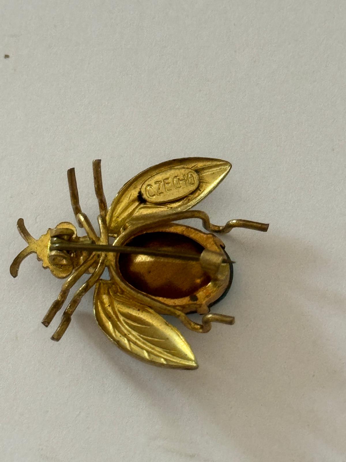 Striking Art Deco stamped Czech glass bug pin